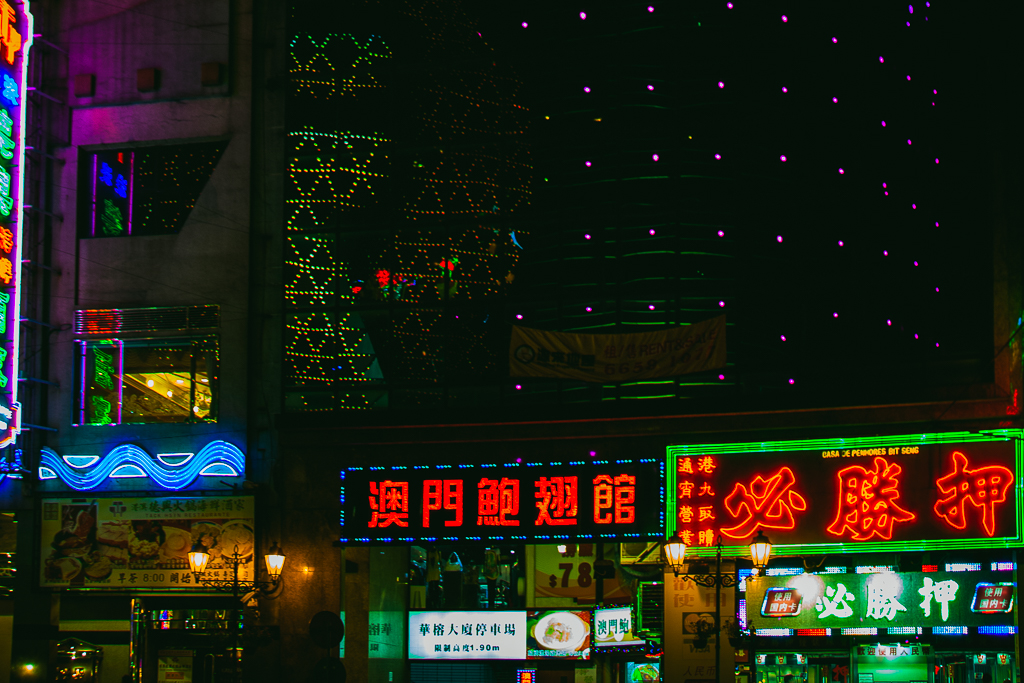 A close up of neon signs at night.