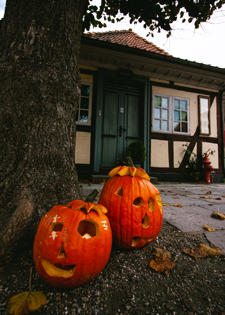 Two carved pumpkins in front of the house cross from the Hans Christian Andersen Museum.